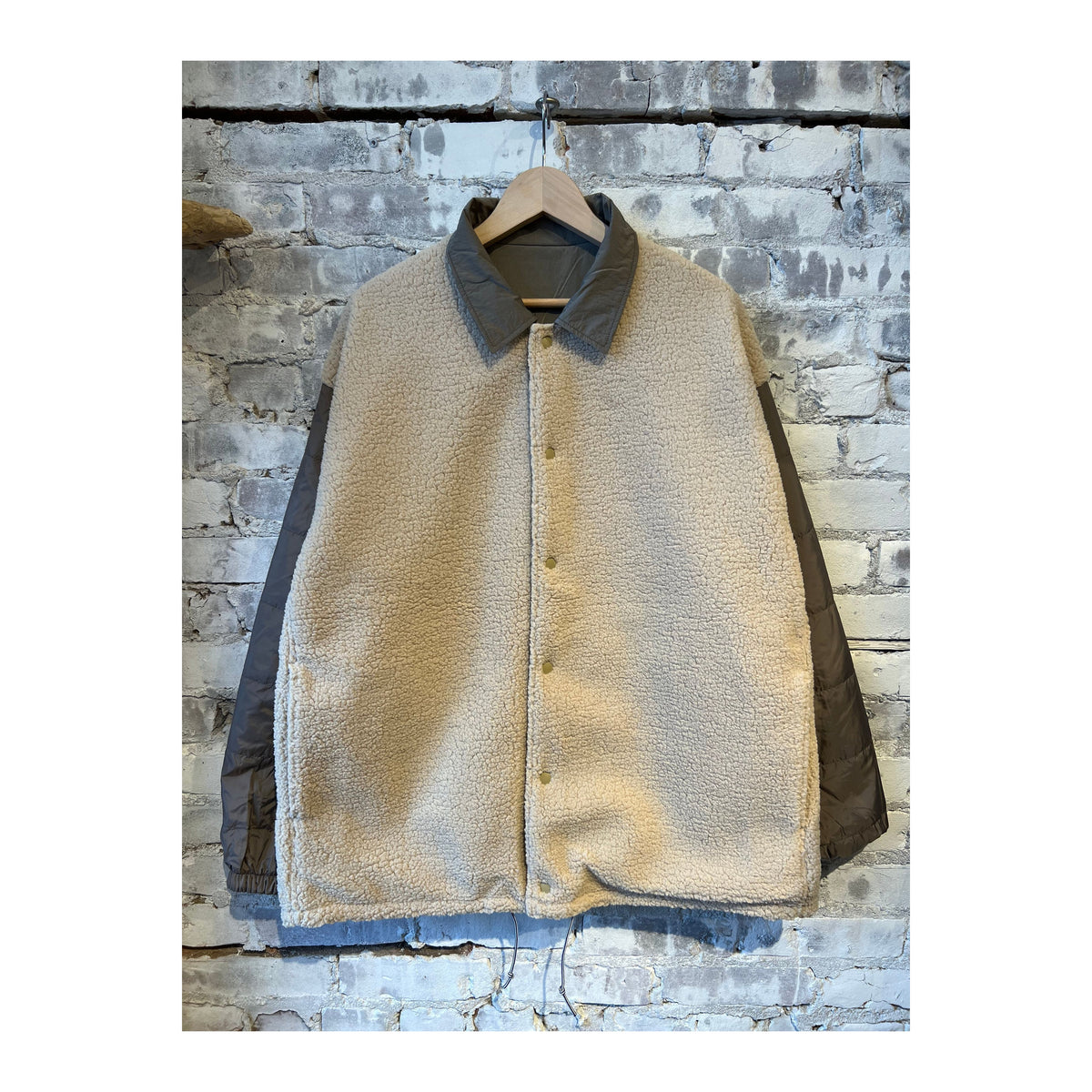 Men's reversible wind jacket in beige by nanamica, showing both outer windproof fabric and inner lightweight layer.