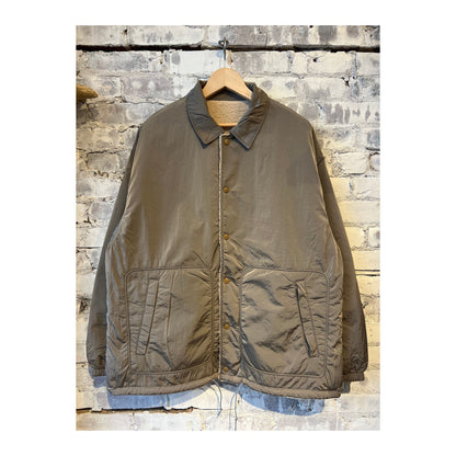 Men's beige reversible wind jacket by nanamica, showing both outer and inner sides with lightweight, windproof fabric.