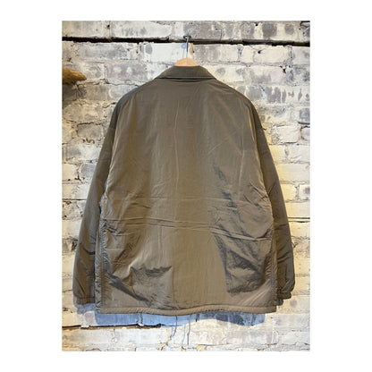 Men's beige reversible wind jacket by nanamica, showing front and back views with lightweight, wind-resistant fabric.