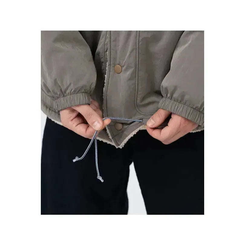 Men's reversible beige wind jacket by nanamica, showing front and back views with lightweight, windproof fabric.