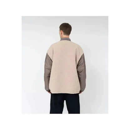 Men's reversible beige wind jacket by nanamica, showing front and back views of lightweight, windproof outdoor outerwear.