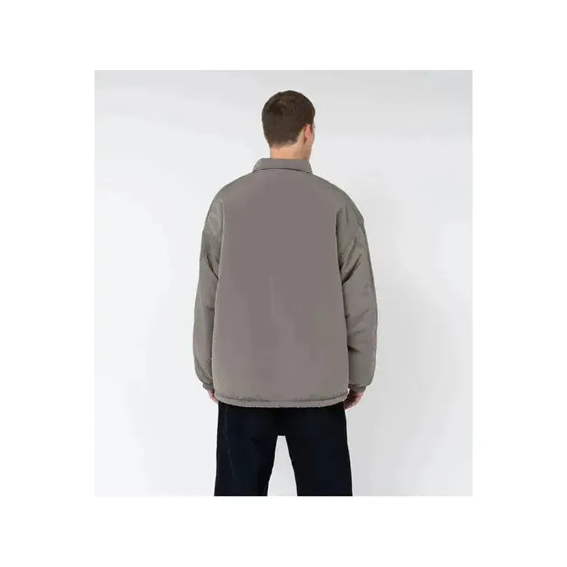 Men's reversible wind jacket in beige by nanamica, shown with both outer and inner sides visible in the image.
