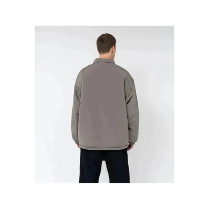 Men's reversible wind jacket in beige by nanamica, shown with both outer and inner sides visible in the image.