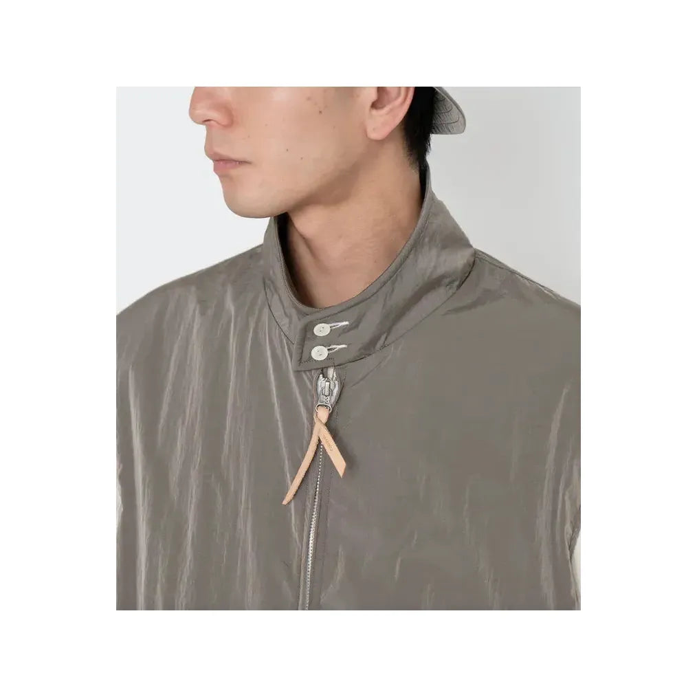 Men's beige nanamica zip-up wind vest, lightweight and stylish, shown on a mannequin against a neutral background.