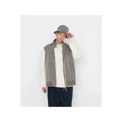 Men's beige zip-up wind vest by nanamica, lightweight outerwear with a stand-up collar and full front zipper.