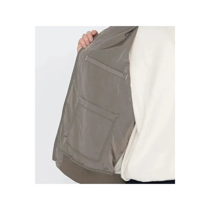 Men's beige nanamica zip-up wind vest, lightweight and stylish, shown on a neutral background.