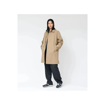 Beige women's GORE-TEX Soutien Collar Coat by nanamica, shown on a hanger with a focus on the collar and fabric texture.
