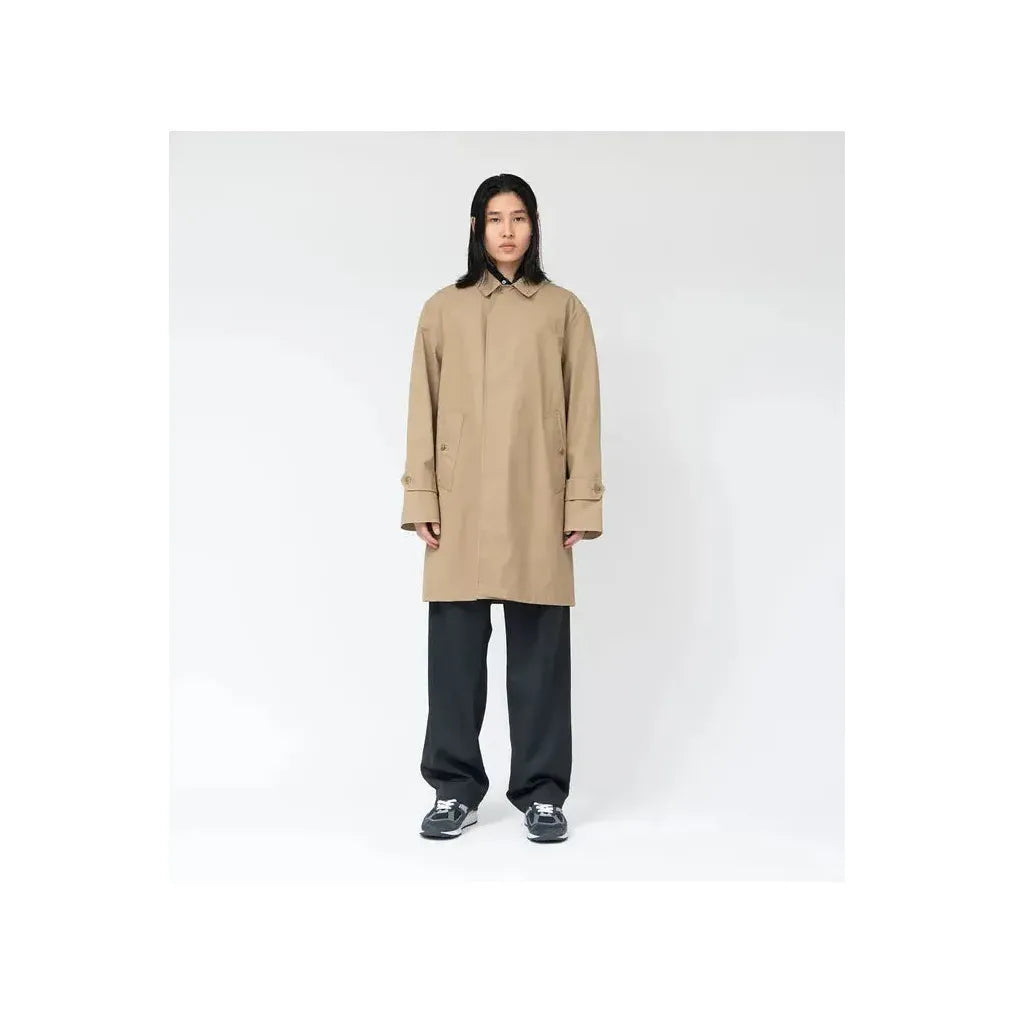 Women's beige nanamica GORE-TEX Soutien Collar Coat showing the collar, waterproof fabric, and tailored fit.