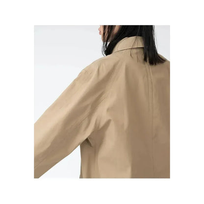 Women's beige nanamica GORE-TEX Soutien Collar Coat, showcasing the stylish collar and waterproof fabric.