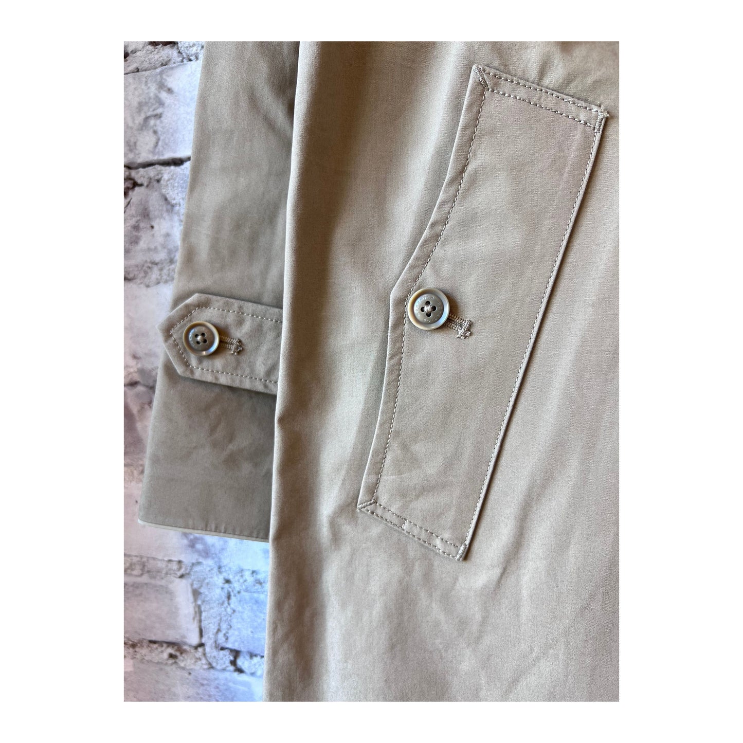 Women's beige GORE-TEX Soutien collar coat by nanamica, showcasing its stylish collar and waterproof fabric.