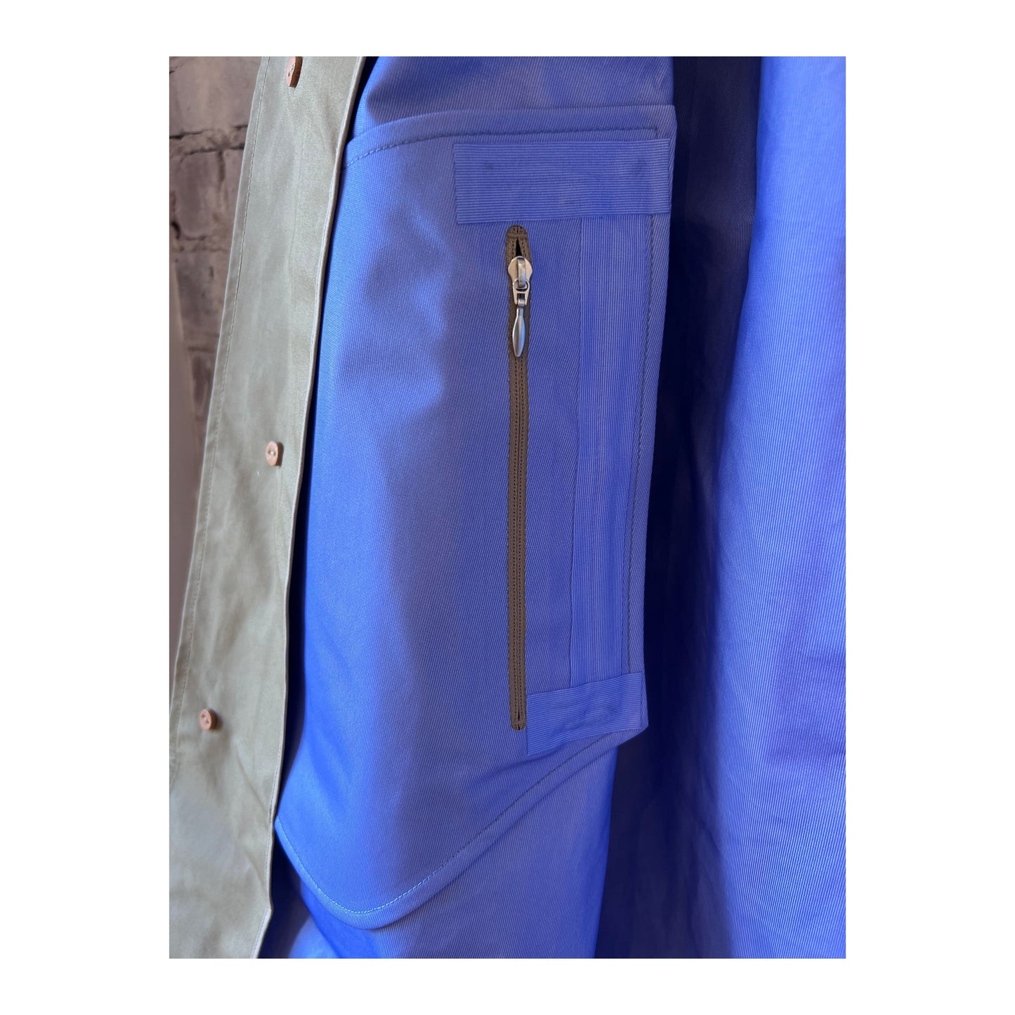 Women's beige GORE-TEX Soutien Collar Coat by nanamica, featuring a stylish collar and waterproof fabric for outdoor wear.
