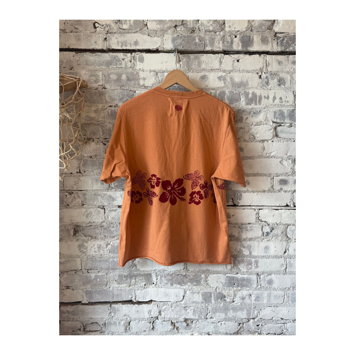 Men's Nectar Raw Hem Tee in Red Earth by MONOSTERO, featuring a casual fit with a raw hem detail and vibrant red color.