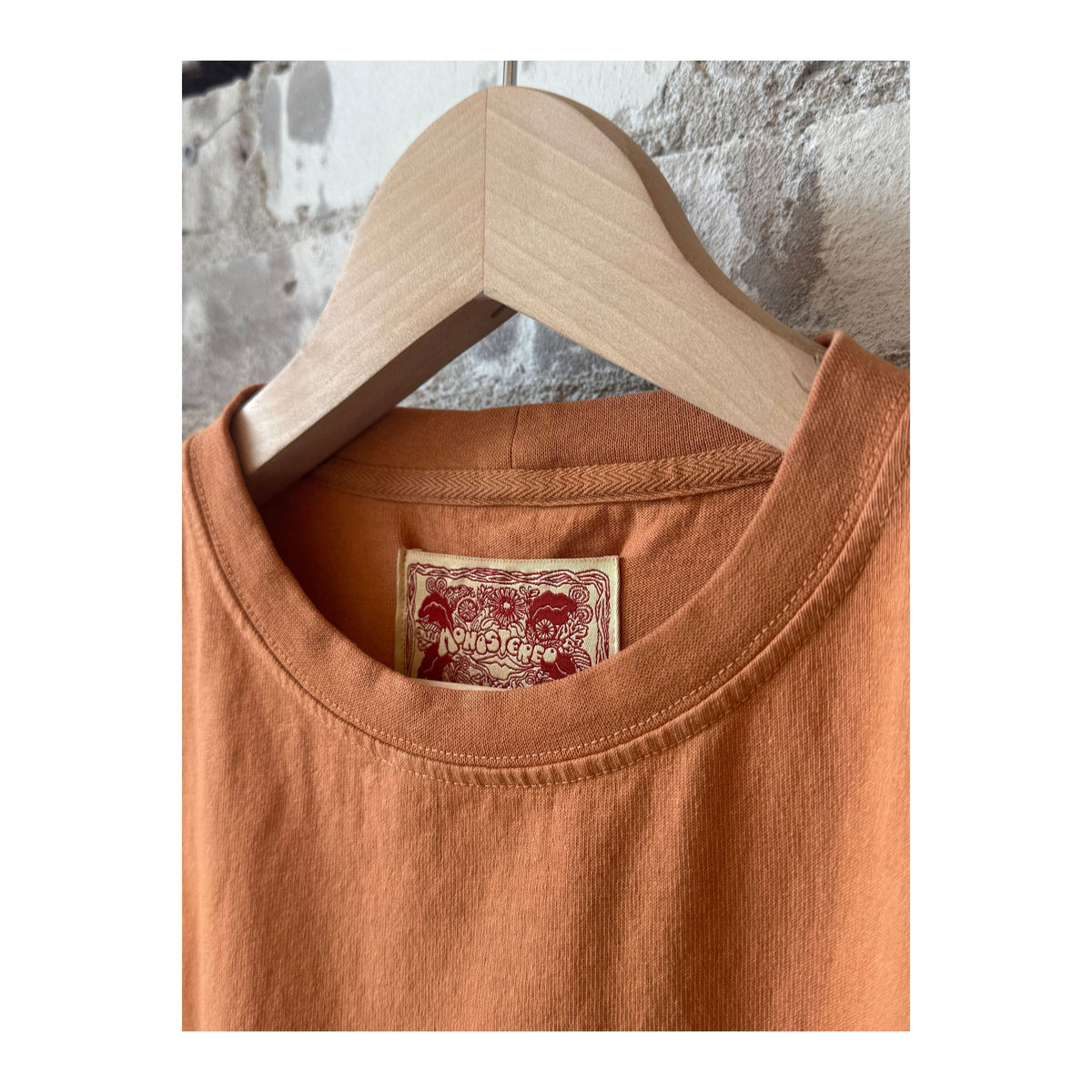 Men's Nectar Raw Hem Tee by MONOSTERO in Red Earth, showcasing the casual red t-shirt with raw hem detail.