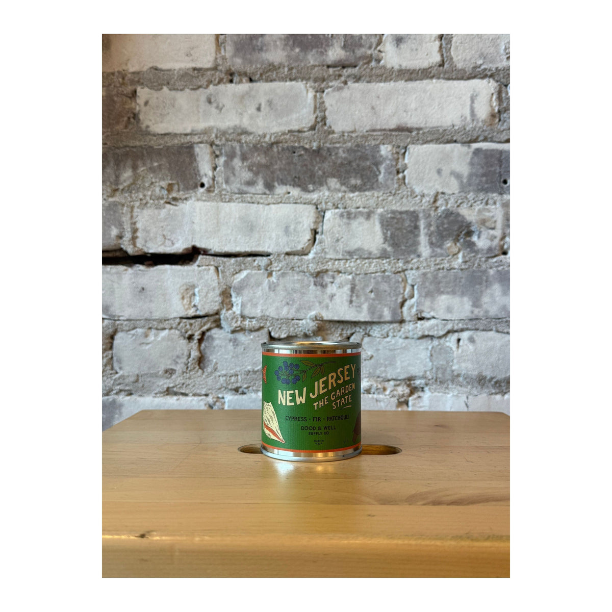 New Jersey State Soy Candle by Good & Well Supply Co. displayed in a glass jar, showcasing the candle with a warm, inviting glow