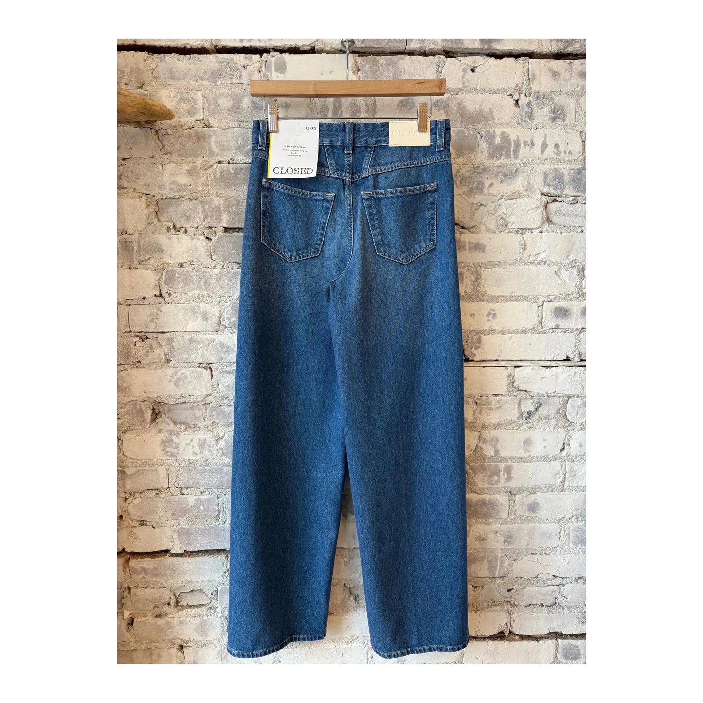 Closed Women's Nikka Wide Jean in mid blue denim, featuring a relaxed fit and classic five-pocket design, worn by a woman.