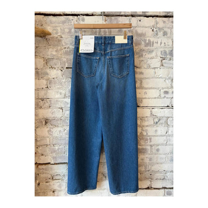 Closed Women's Nikka Wide Jean in mid blue denim, featuring a relaxed fit and classic five-pocket design, worn by a woman.
