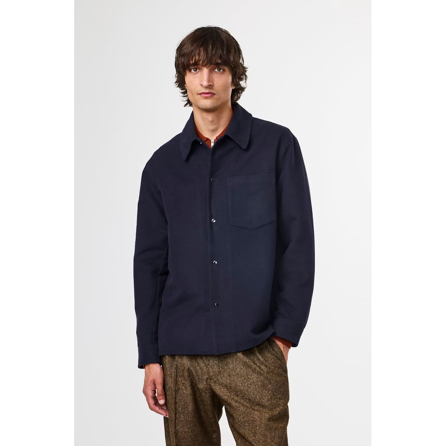 Men's navy Blaze Organic Cotton Overshirt by NN07, featuring a casual fit and organic fabric, displayed hanging on a wooden hanger.
