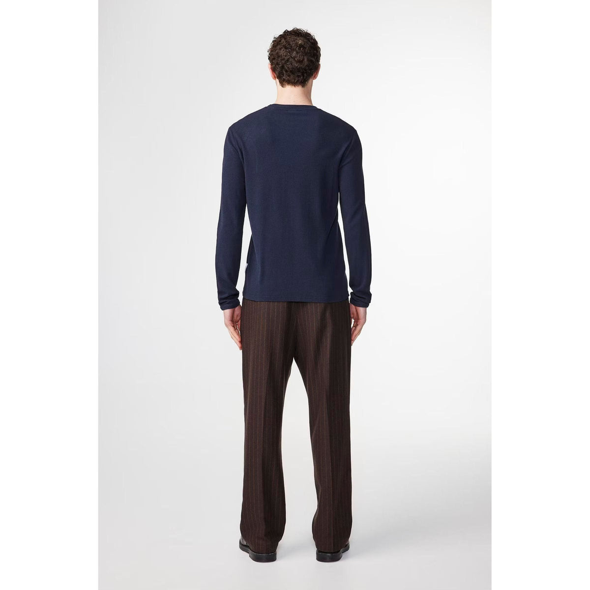 Navy blue NN07 Clive waffle knit men's T-shirt displayed on a hanger, showcasing its textured fabric and casual fit.