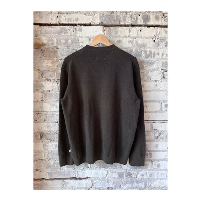 Men's Danny Sweater in Dark Army by NN07, close-up of the dark green knitted sweater showing its textured fabric and fit.