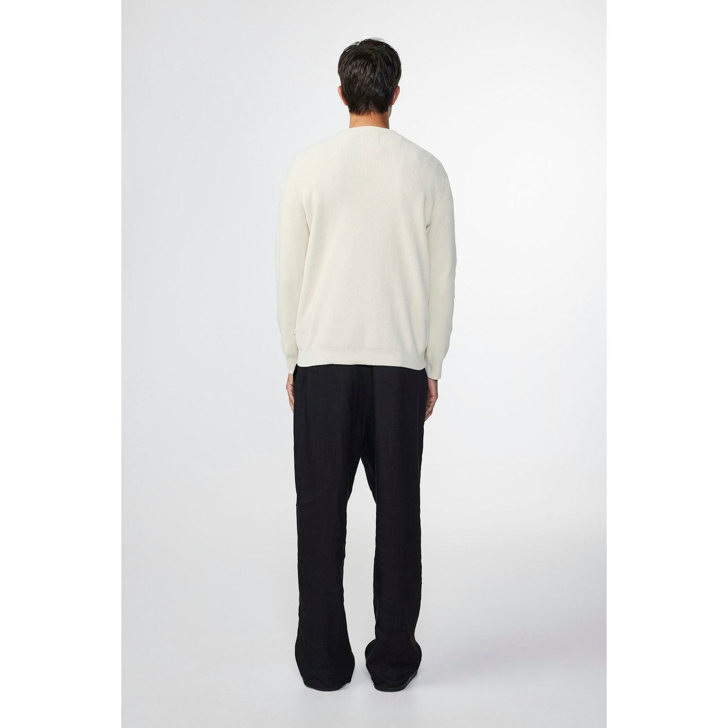 Men's NN07 Danny Sweater in ecru, soft knit fabric, featuring a classic crew neck and long sleeves, laid flat.