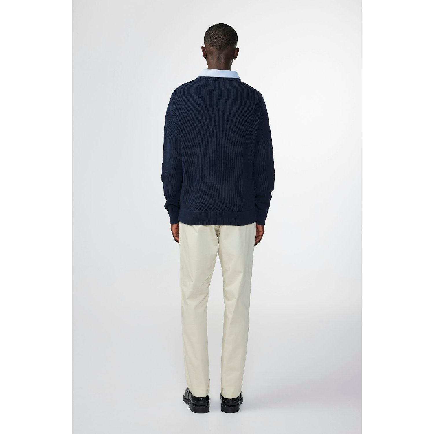 Men's navy Kevin ribbed organic cotton sweater by NN07, close-up of textured knit fabric and ribbed cuffs.