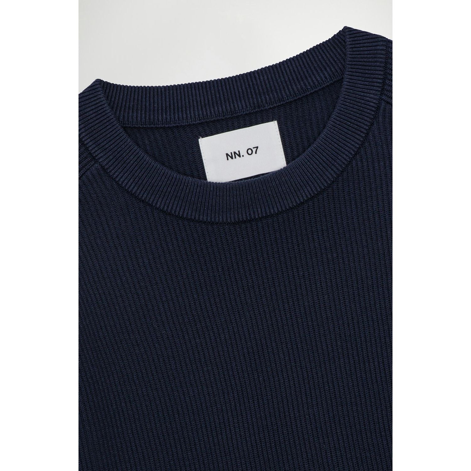 Men's navy Kevin ribbed organic cotton sweater by NN07, featuring a close-up of the textured knit fabric.