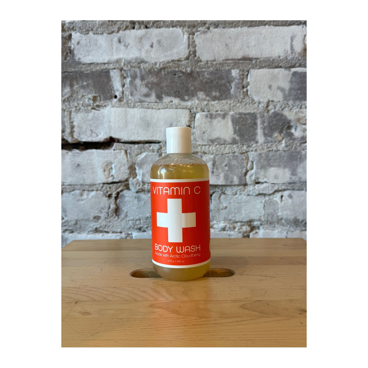Nordic+Wellness™ Vitamin C Body Wash by Kalastyle Soap Co., close-up of the sleek bottle with vibrant citrus imagery.