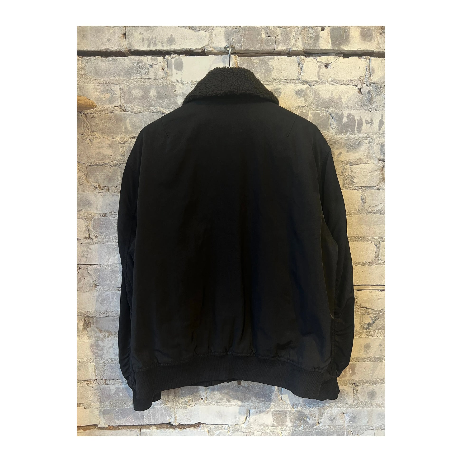 Men's black nylon flight jacket by Closed Men's, featuring a sleek ebony design with a zip-up front and collar.