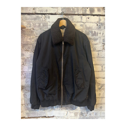 Men's nylon flight jacket in ebony with a sleek design, featuring a front zipper and ribbed cuffs, by Closed Men's.