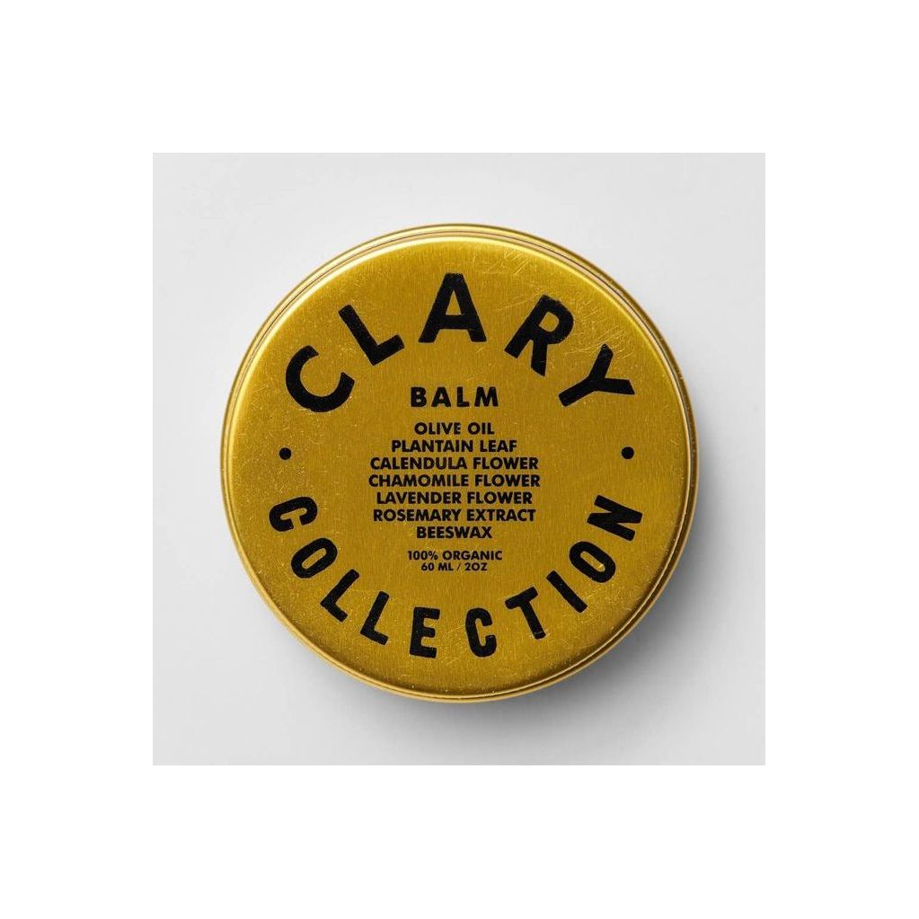 Clary Collection Olive Balm 2oz jar, featuring a sleek black lid and label, placed on a rustic wooden surface.