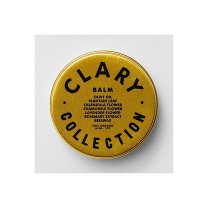 Clary Collection Olive Balm 2oz jar, featuring a sleek black lid and label, placed on a rustic wooden surface.
