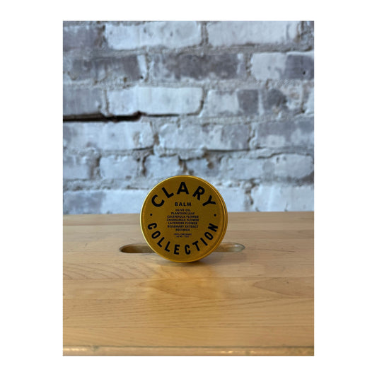 Clary Collection Olive Balm 2oz jar, natural skincare accessory with a green olive-inspired design and a white screw-on lid.
