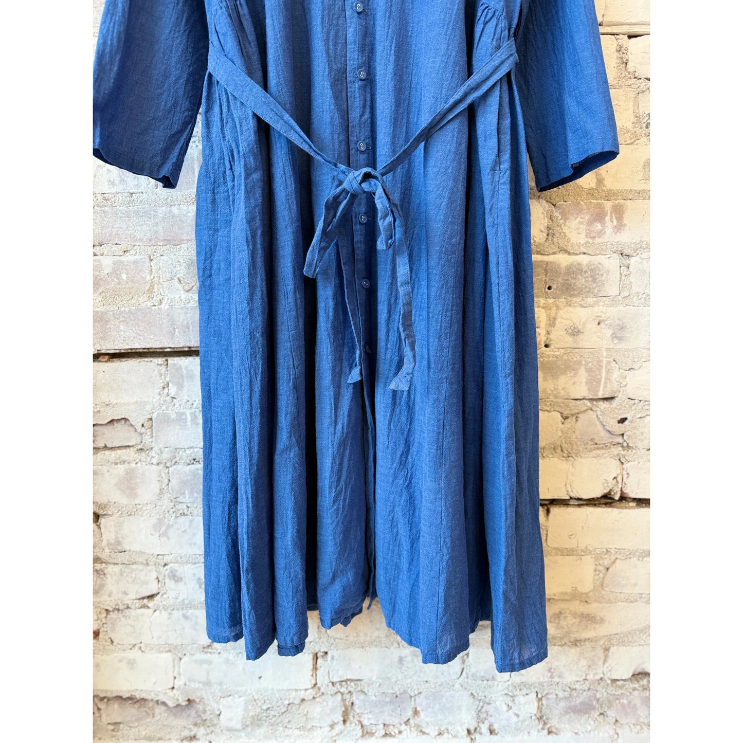Women's organic cotton chambray dress in cobalt by Pas De Calais, featuring a relaxed fit and classic button-down style.