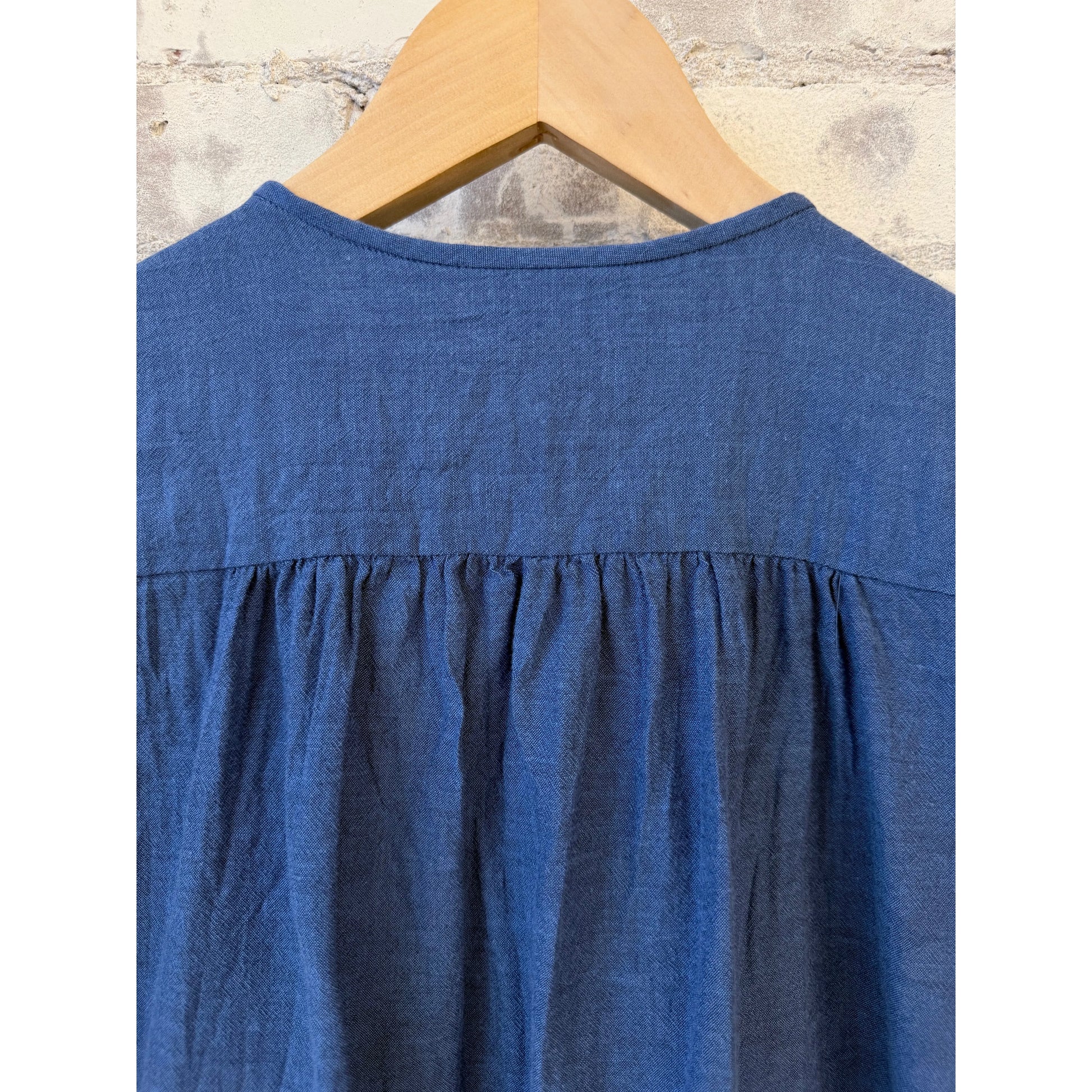 Women's organic cotton pleated blouse in cobalt by Pas De Calais, featuring a stylish, flowing design and pleated details.