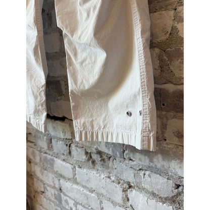 Women's white kite pant by Freecity with poplin fabric, air flap, and snap closure, featuring a relaxed fit and subtle design details.