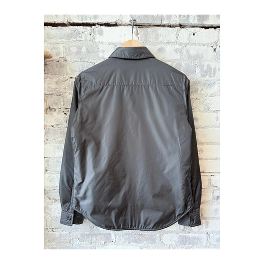Women's grey padded nylon overshirt by Aspesi, shown in a close-up image highlighting the fabric texture and tailored fit.