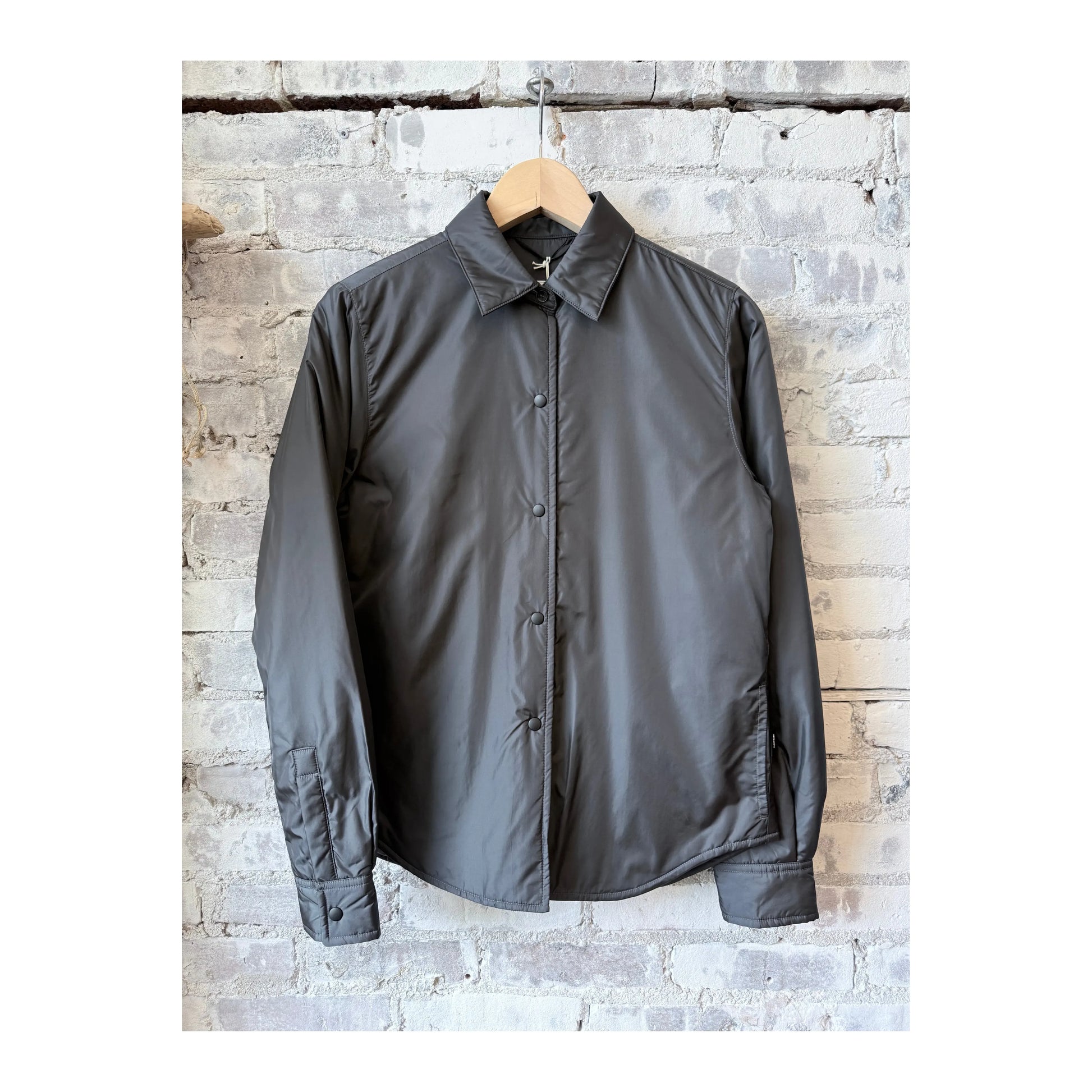 Women's grey padded nylon overshirt by Aspesi, showcasing a sleek, padded design with a casual, stylish fit.