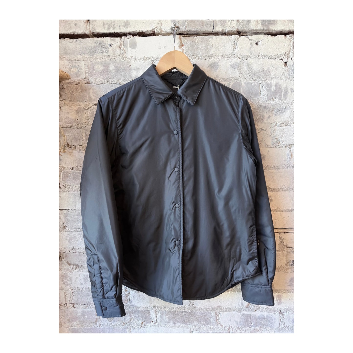 Women's navy padded nylon overshirt by Aspesi, featuring a quilted design and casual fit, suitable for layering and outdoor wear.