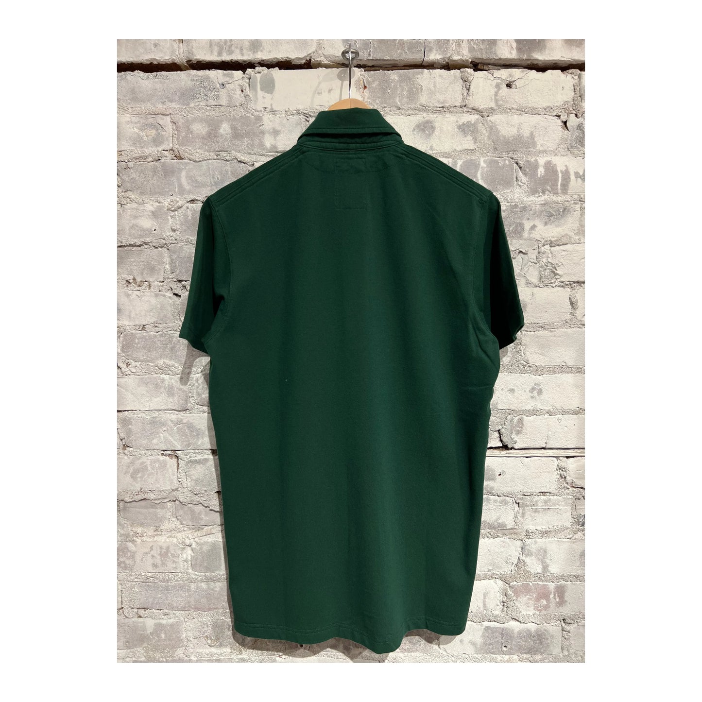Men's forest green Pique Slot Polo by Relwen, featuring a classic polo shirt design with a collar and short sleeves.