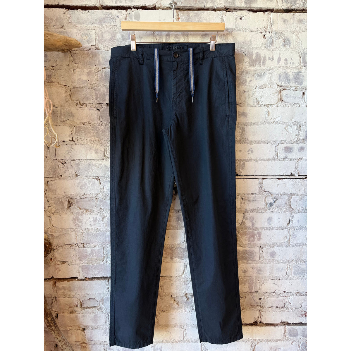 Men's navy poplin chino trousers by Aspesi, shown hanging with a tailored fit and classic design.