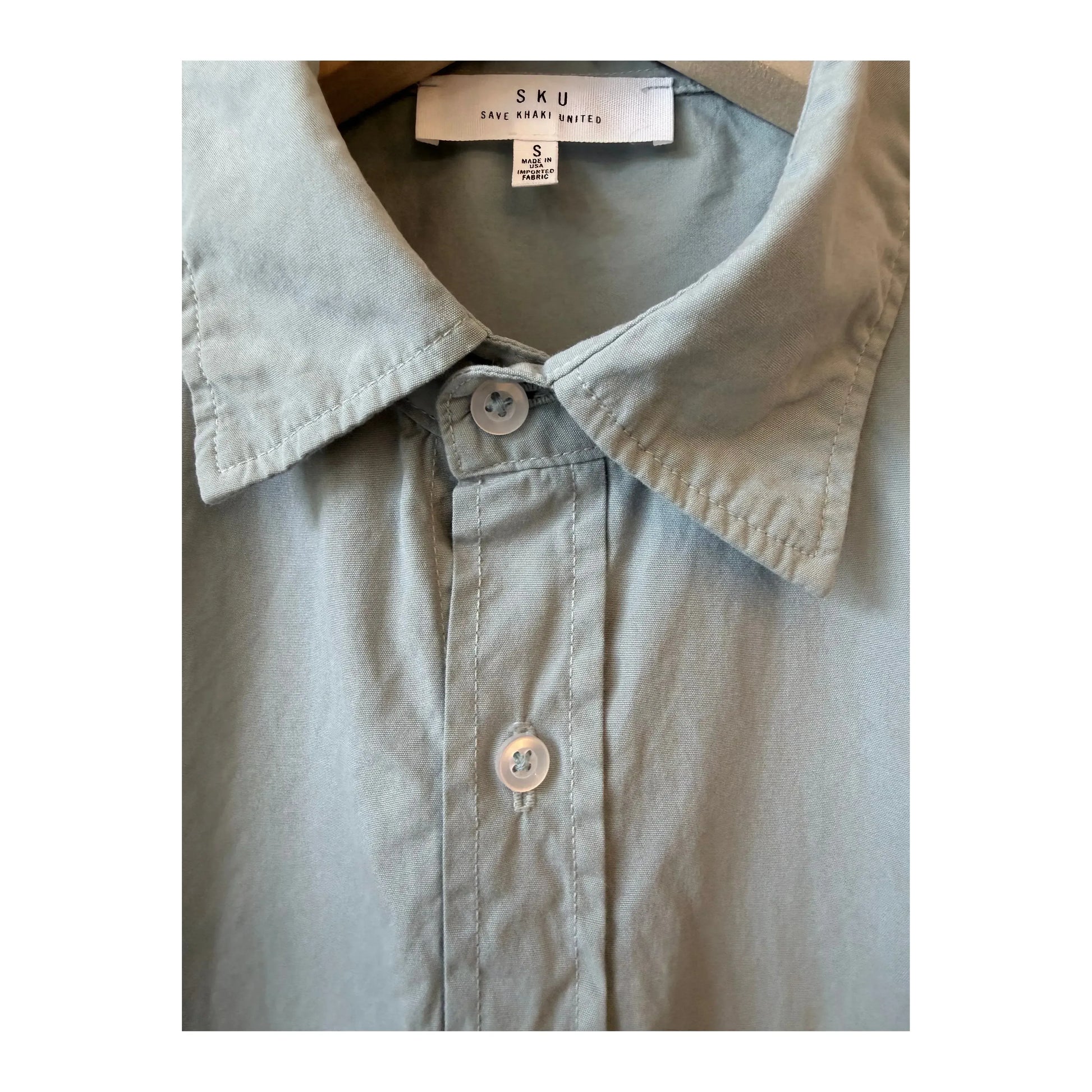 Men's Save Khaki United surf poplin standard shirt in a classic design with a relaxed fit, displayed on a hanger.