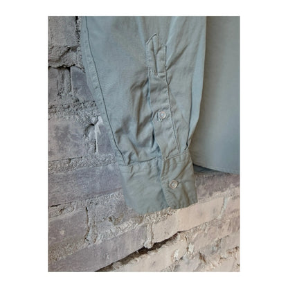 Men's Save Khaki United Poplin Standard Shirt in Surf blue, lightweight cotton fabric, shown on a hanger.