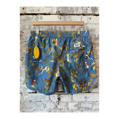 Men's printed swim trunks featuring a blue parrot design by Hartford Men's, displayed in a vibrant, colorful image.