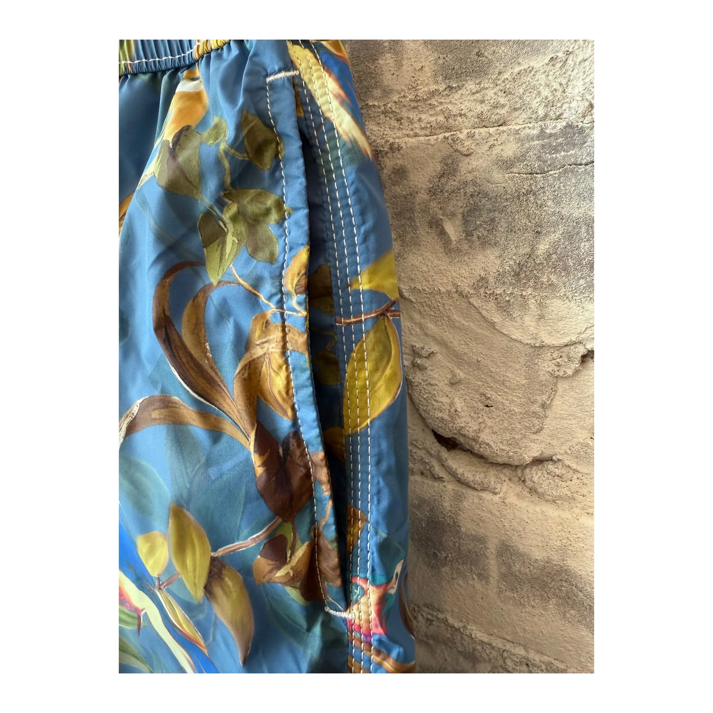 Men's blue printed swim trunks by Hartford Men's featuring a colorful parrot design, perfect for beach or poolside wear.