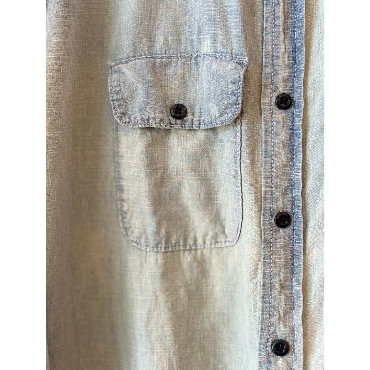 Men's Raw Hem Hemp Chambray Long Sleeve Shirt in Light Wash by MONOSTERO, featuring a casual raw hem and soft fabric.