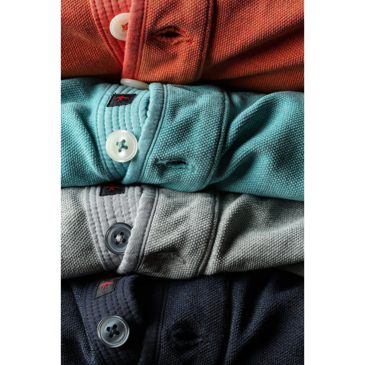 Men's Relwen Pique Button Mock in Ocean Heather, close-up of the textured fabric and button details on the shirt.