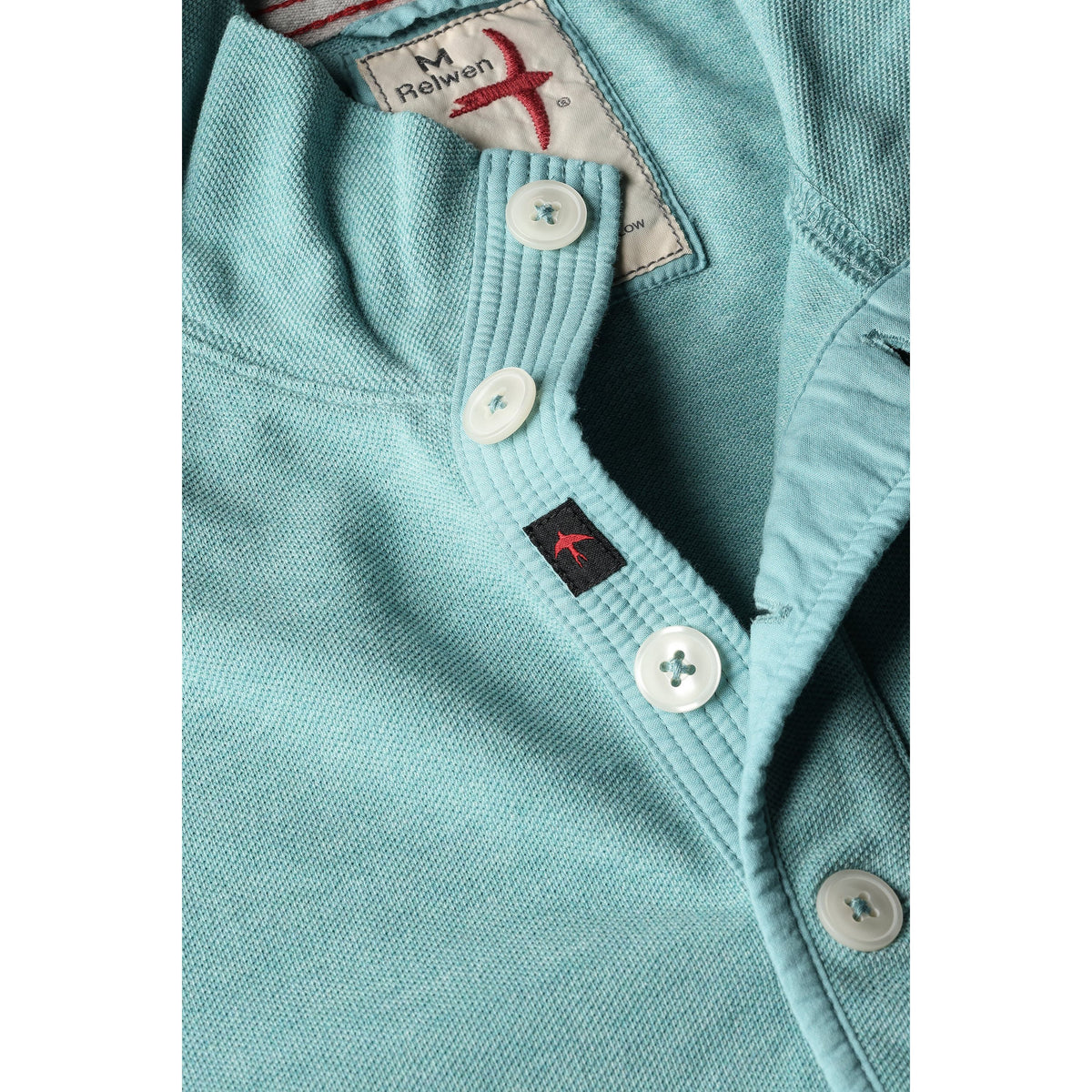 Men's Relwen Pique Button Mock in Ocean Heather, close-up of textured knit fabric with button detail.