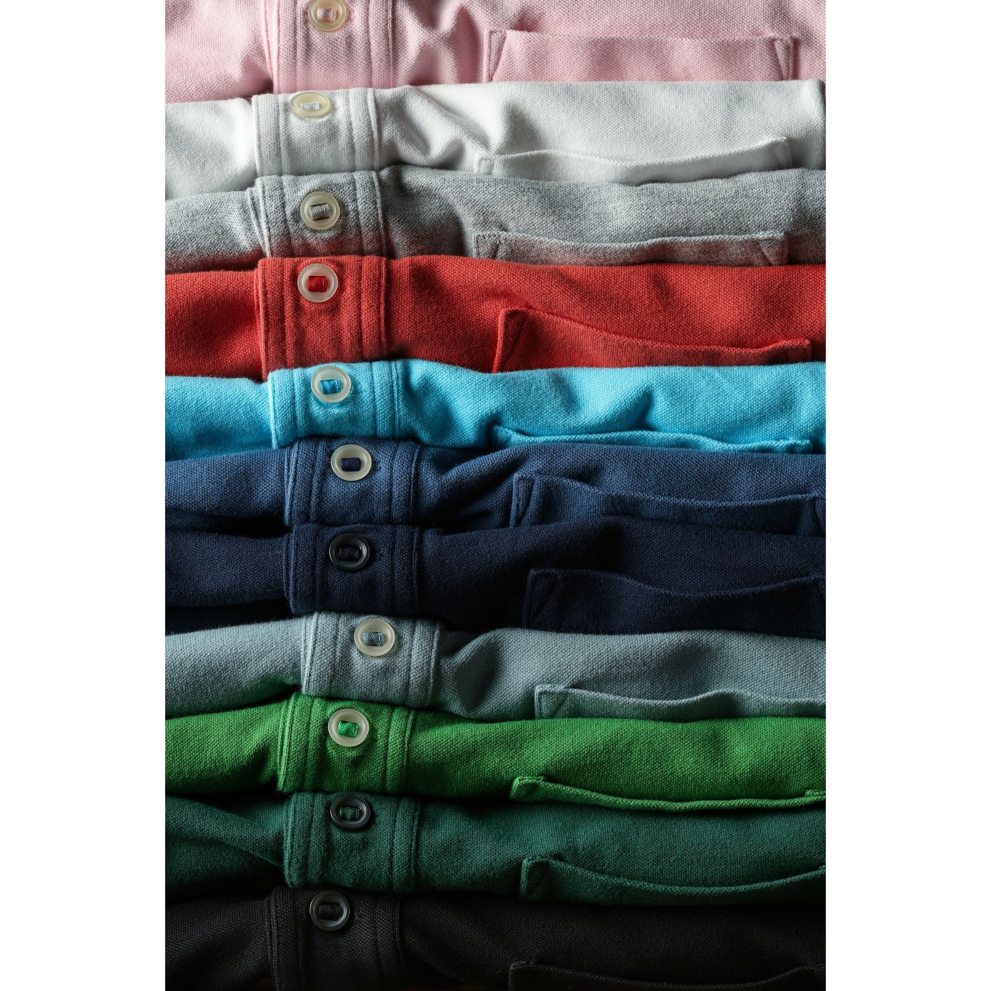 Men's pale pink Pique Slot Polo by Relwen, displaying a classic collared polo shirt with a textured pique fabric.