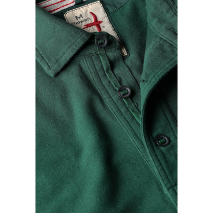 Men's forest green pique slot polo shirt by Relwen, showing a close-up of the textured fabric and classic collar detail.