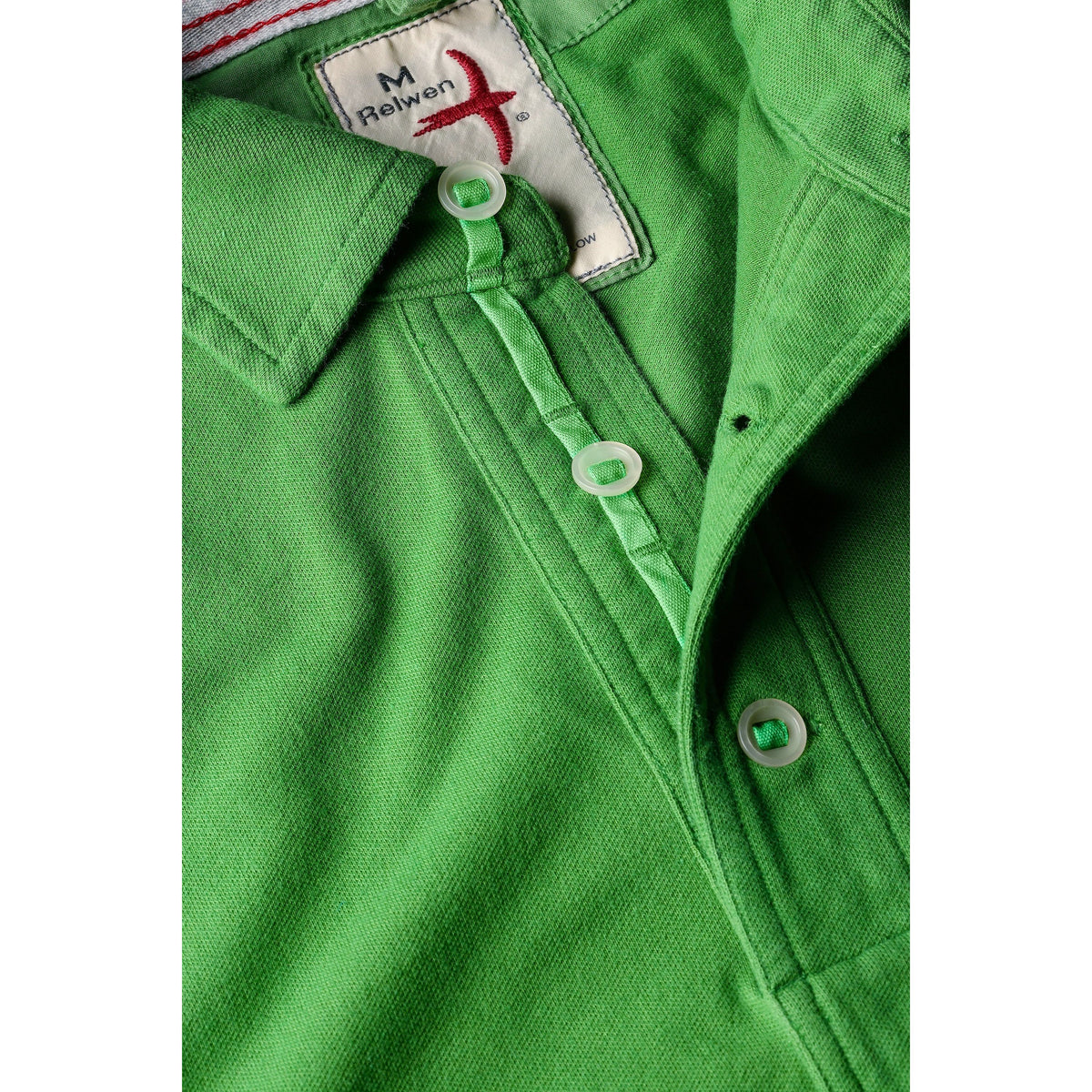 Men's lawn green Pique Slot Polo by Relwen, close-up of the textured cotton fabric and classic polo collar.